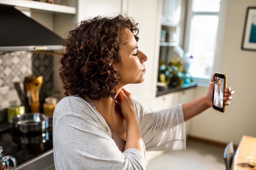 Woman having a video call with a doctor