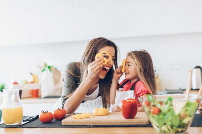 family-cooking A woman and child cooking in a kitchen